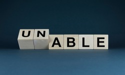 Able or unable. The dice form an able or un-able expression. Business Concept