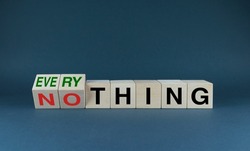Everything or nothing. The cubes form the choice words Everything or nothing. Concept of risks and ambitions in business