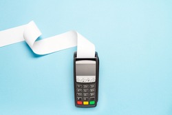 pos terminal with long cash register tape on blue background. shopping theme