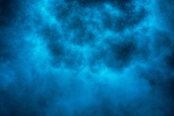 Explosion of blue powder, smoke background.