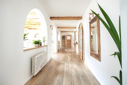 Wooden handmade mirror in hallway boho interior. Home indoors design concept.