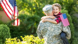Happy reunion of soldier with family, son hug father