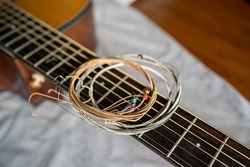 old steel guitar strings on acoustic guitar neck