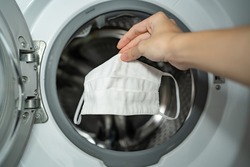 Putting cloth face mask into the washing machine