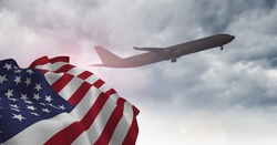 Composition of airplane flying against american flag and sky. united states of america travel, patriotism and independence concept digitally generated image.