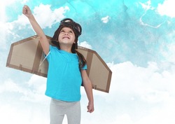 Dgital composite of smiling kid pretending to be a pilot against clouds