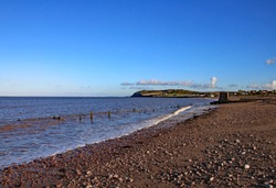 The deserted stony beach at Blue Anchor in Somerset, England