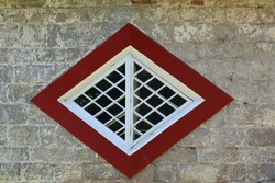 An unusual diamond shaped window on a historic house in Devon, England