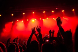 hands fans during a concert