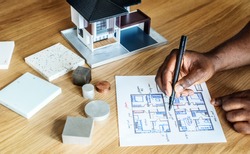 People sketching house plan blueprint