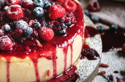 Closeup of a cheesecake covered with mixed berries