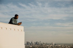 Black man enjoying the view of Los Angeles city from the Griffith Observatory, USA