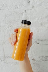 Woman holding a bottle of orange juice