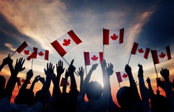 Silhouettes of People Holding Flag of Canada