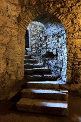 Stone arch and steps in underground castte