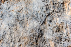 background and texture of mountain layers and cracks in sedimentary rock on cliff face. Cliff of rock mountain. 