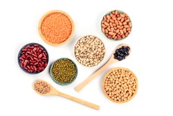 Various types of pulses, shot from the top on a white background. Red kidney, pinto, and black beans, lentils, chickpeas, soybeans, and black-eyed peas