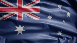 Australian flag waving in the wind. Close up of Australia banner blowing, soft and smooth silk. Cloth fabric texture ensign background. Use it for national day and country occasions concept.