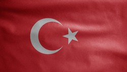 Turkish flag waving in the wind. Close up of Turkey banner blowing, soft and smooth silk. Cloth fabric texture ensign background. Use it for national day and country occasions concept.