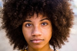 portrait and close up of beautiful young African or American woman looking at the camera