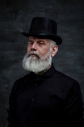 Victorian old man dressed in black suit and top hat