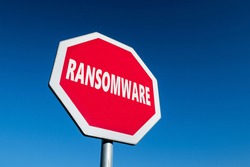 Stop sign with a text RANSOMWARE to cease malware attacks and protect against them