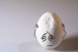 Egg with headache, problem and pain, his aching head covered by hands