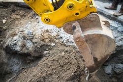 Close up of a power shovel/excavator digging road. 