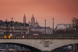 Perspective shoot of Basilica of Sacre Coeur (Sacred Heart) on Montmartre and Pont d'Iena Bridge over Seine in Paris