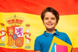Smiling schoolboy learning Spanish