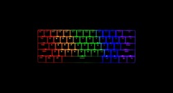 Mechanical gaming keyboard lit up with RGB LED lights. 65% size keyboard. Colors include red, green and blue. Isolated on its own, as a product photo. Plain black background. Copy space to add text.