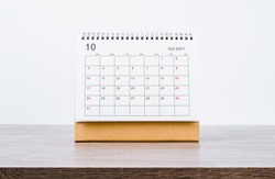 October Calendar 2021 on wooden table background.