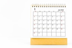 The January 2022 desk calendar on wooden table.