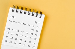 The April 2022 desk calendar on light yellow background.