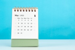 The mini May 2022 desk calendar on blue background.