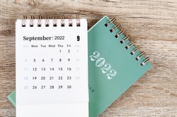 The September 2022 desk calendar on wooden background.
