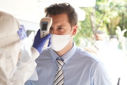 Disease control experts  use an Infrared thermometer equipment to check the temperature on the forehead and use alcohol gel to screen the patients addicted to Covid before entering the building.