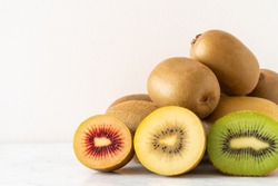 Three Varieties of Kiwi Fruit on a Table, Horizontal with Copy Space