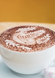 Large Hot Chocolate on a Cafe Table with Fern Decorations, Selective Focus