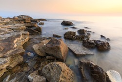 Colorful sunset on a beach with rocks on the Adriatic Sea coast Istria Croatia