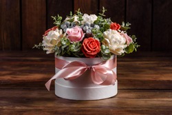 Bouquet of beautiful bright rose flowers in a gift cylindrical cardboard box. Gift bouquet of soap flowers