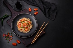 Delicious fresh noodles with sweet pepper, tomato, spices and herbs. Asian cuisine