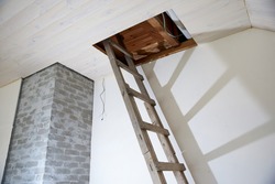 Wooden staircase to the attic in the house during repair
