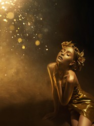 fantasy woman autumn queen, face in gold paint golden shiny skin. Fashion model girl princess posing. Black studio. Glamorous goddess. Crown, wreath roses flowers jewellery accessories metallic makeup