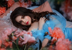 Portrait fantasy woman sleeping beauty lies on comfortable bed soft pillow. Background mystical garden, pink peonies flowers green trees. Fairy-tale girl princess cute face red lips makeup, blue dress