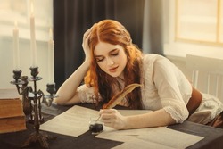 Medieval red-haired woman writer holds pen feather quill in hands, sits at table writes letter on sheet paper. Vintage dress ancient room antique candlestick, old books. Girl smiling student studying
