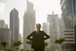 
Confident businesswoman standing strong looking at the city high-rises view. Business ambition and aspire.