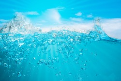 Spectacular ocean waves stop steaming with separate bubbles on a bright sky background. Popular corners, natural concepts