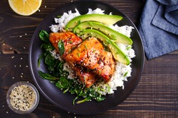 Salmon in honey-soy glaze with rice, spinach and avocado. overhead, horizontal