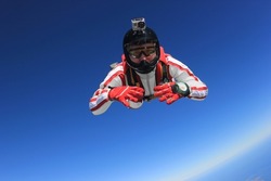 The parachutist is engaged in skydiving.